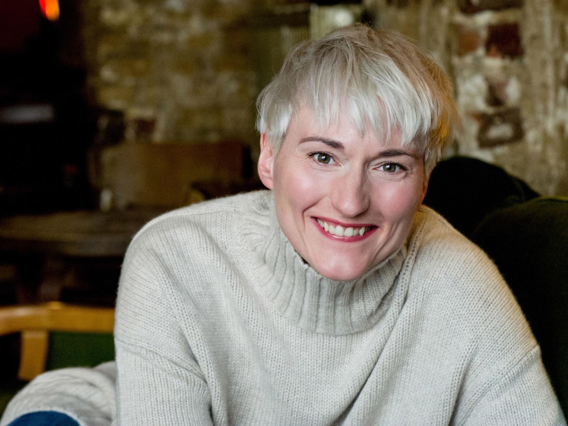 Die Schauspielerin Karola Oswald lacht herzlich.