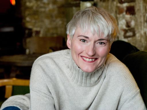 Die Schauspielerin Karola Oswald lacht herzlich.