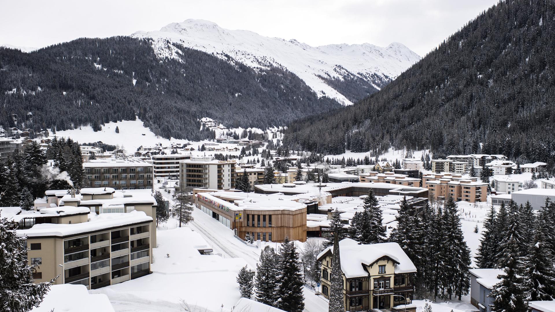 Blick auf die Stadt Davos im Winter. Die Häuser und Berge sind mit Schnee bedeckt.