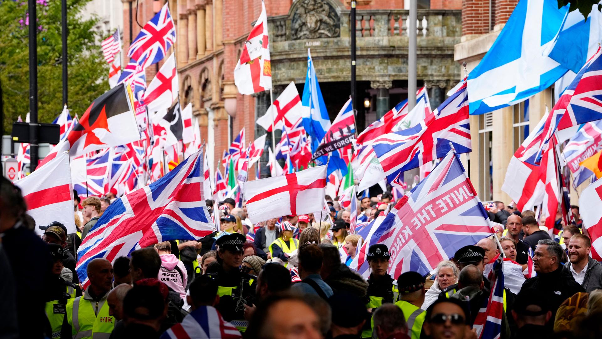 Zahlreiche Menschen protestieren in der britischen Hauptstadt London gegen Einwanderung und schwenken dabei Nationalflaggen.