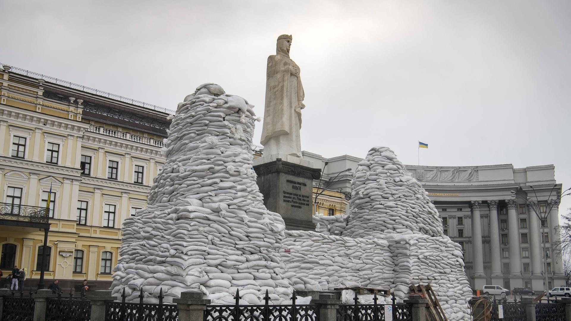 Freiwillige decken im historischen Zentrum von Kiew ein Denkmal der Fürstin Olga, des Apostels Andreas, Kyrills und Methodius' mit Sandsäcken ab, um es vor dem Einmarsch Russlands in die Ukraine zu schützen.