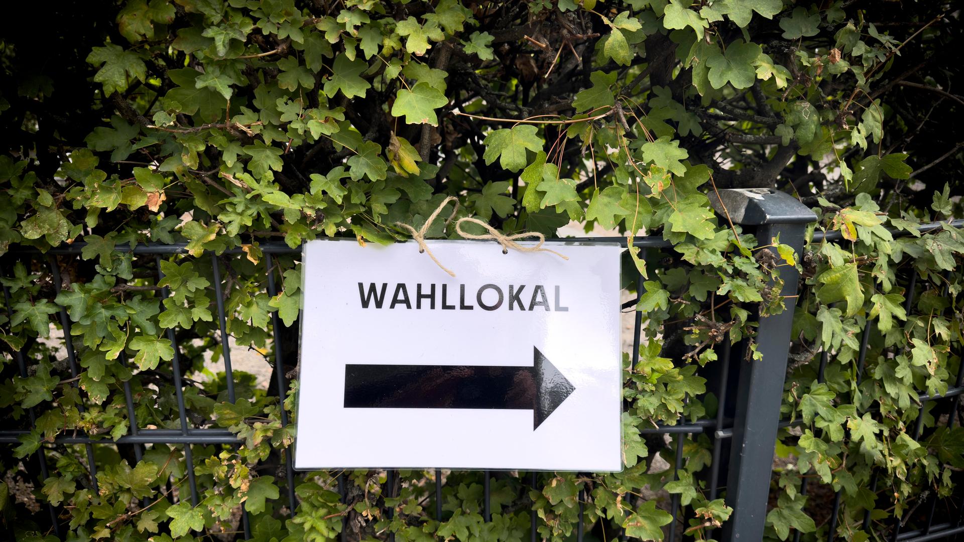 Ein Zettel weißt mit einem Pfeil nach rechts mit dem Hinweis "Wahllokal". 