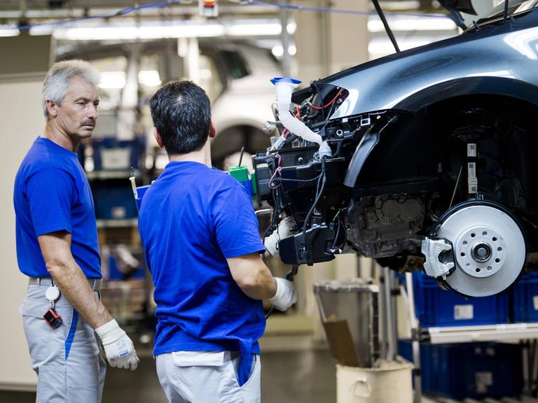 Monteure am Fließband in der Fertigung im Werk der VW AG Wolfsburg.