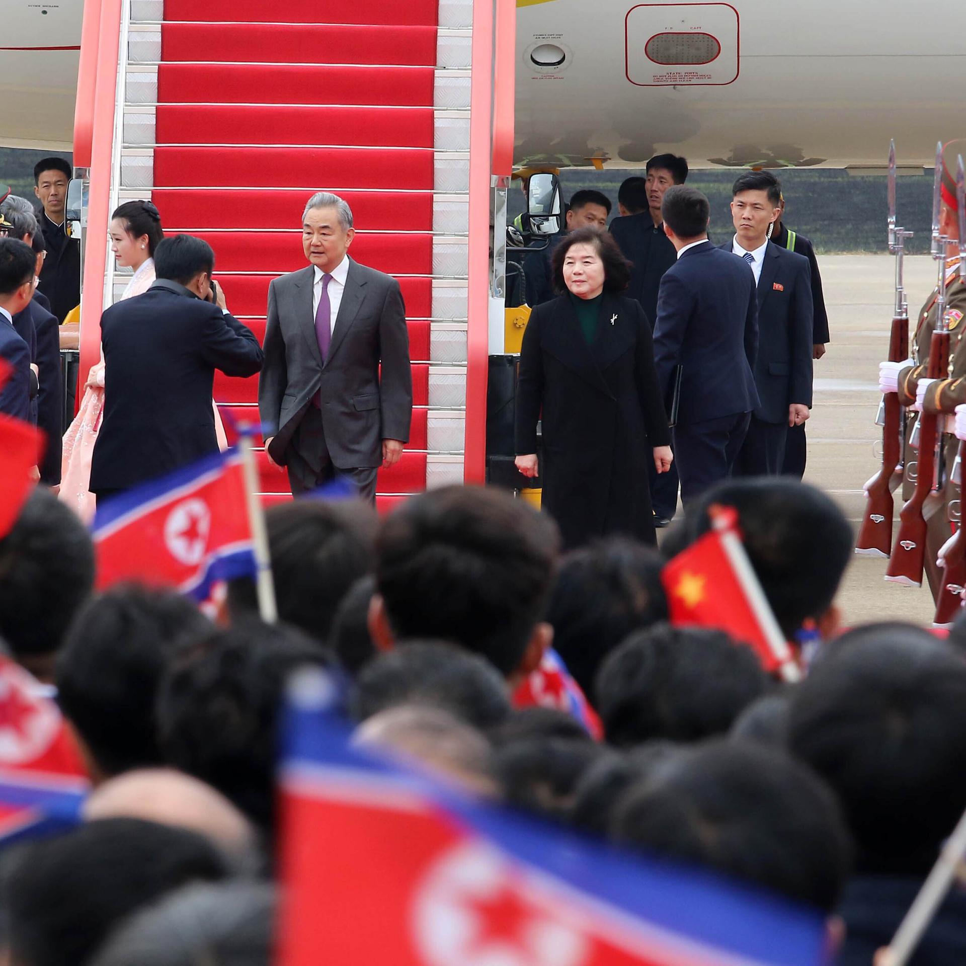 Der chinesische Außenminister Wang wird in Pjöngjang am Flughafen von vielen Menschen und mit militärischen Ehren empfangen.
