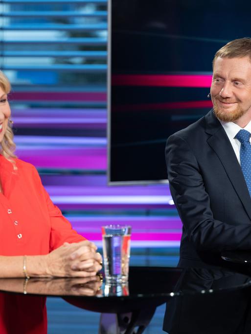 Petra Köpping (SPD), Sozialministerin von Sachsen, und Michael Kretschmer (CDU), Ministerpräsident von Sachsen, stehen vor Beginn der TV-Wahlarena des MDR in einem Saal der Handwerkskammer Dresden nebeneinander.