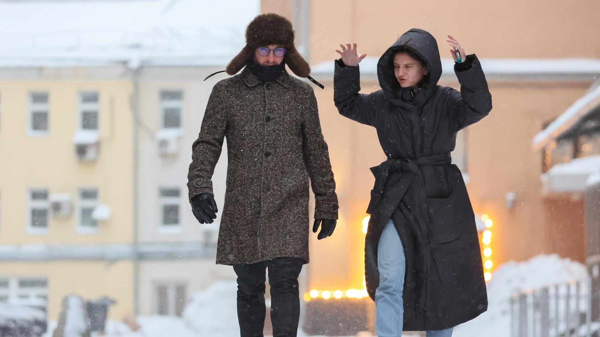 DIESES FOTO WIRD VON DER RUSSISCHEN STAATSAGENTUR TASS ZUR VERFÃGUNG GESTELLT. [RUSSIA, MOSCOW - DECEMBER 10, 2023: A man and a woman walk in a street in central Moscow. Sofya Sandurskaya/TASS]