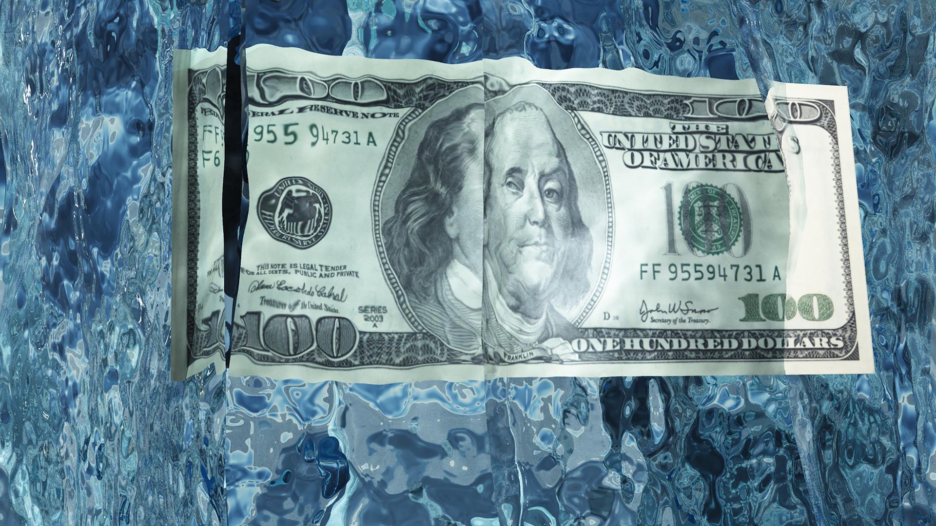 Ein Hundert-Dollar-Schein ist in Eis eingefroren.
