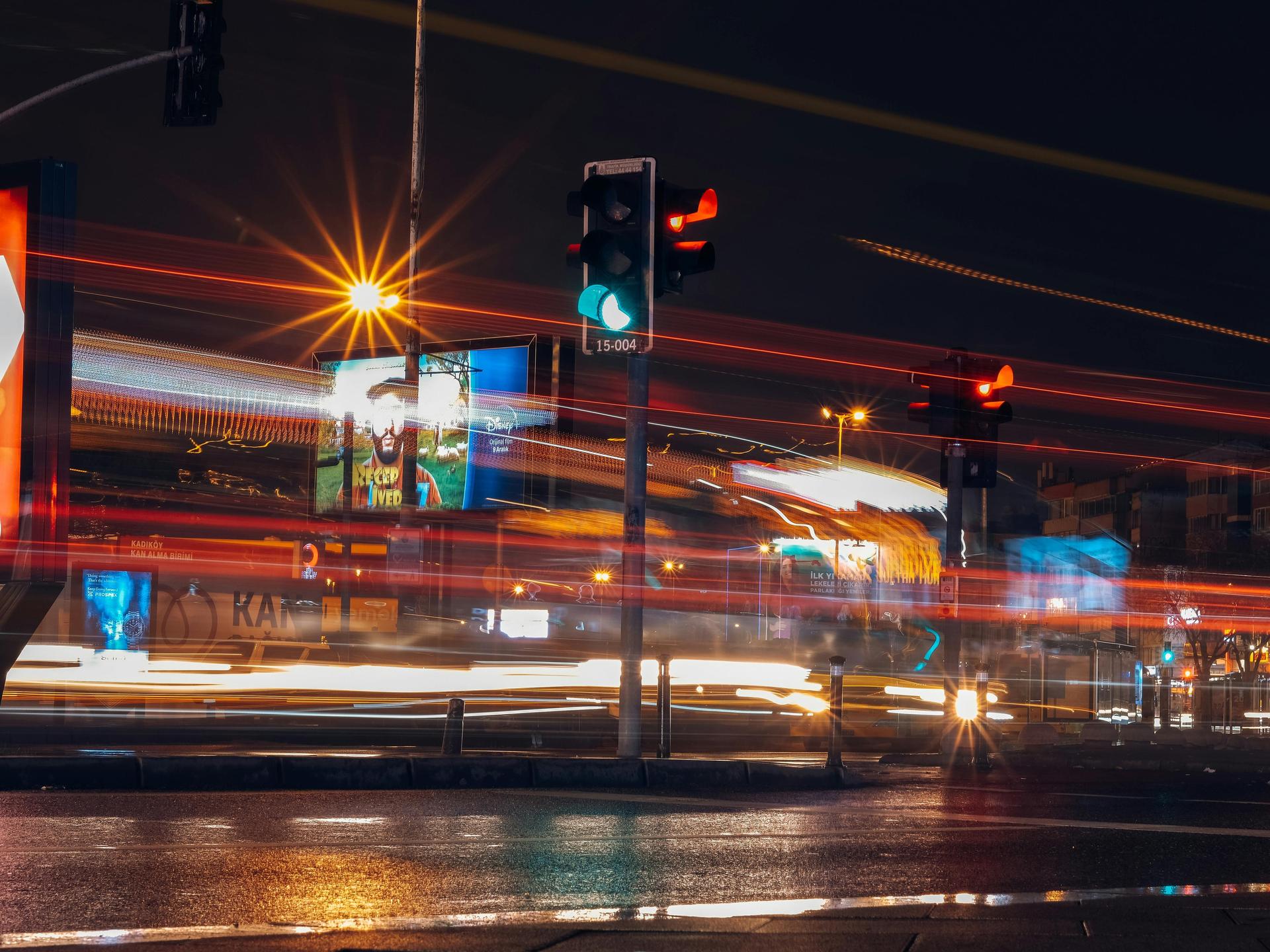 Stadt bei Nacht, eine Straßenbahn fährt über eine Straße