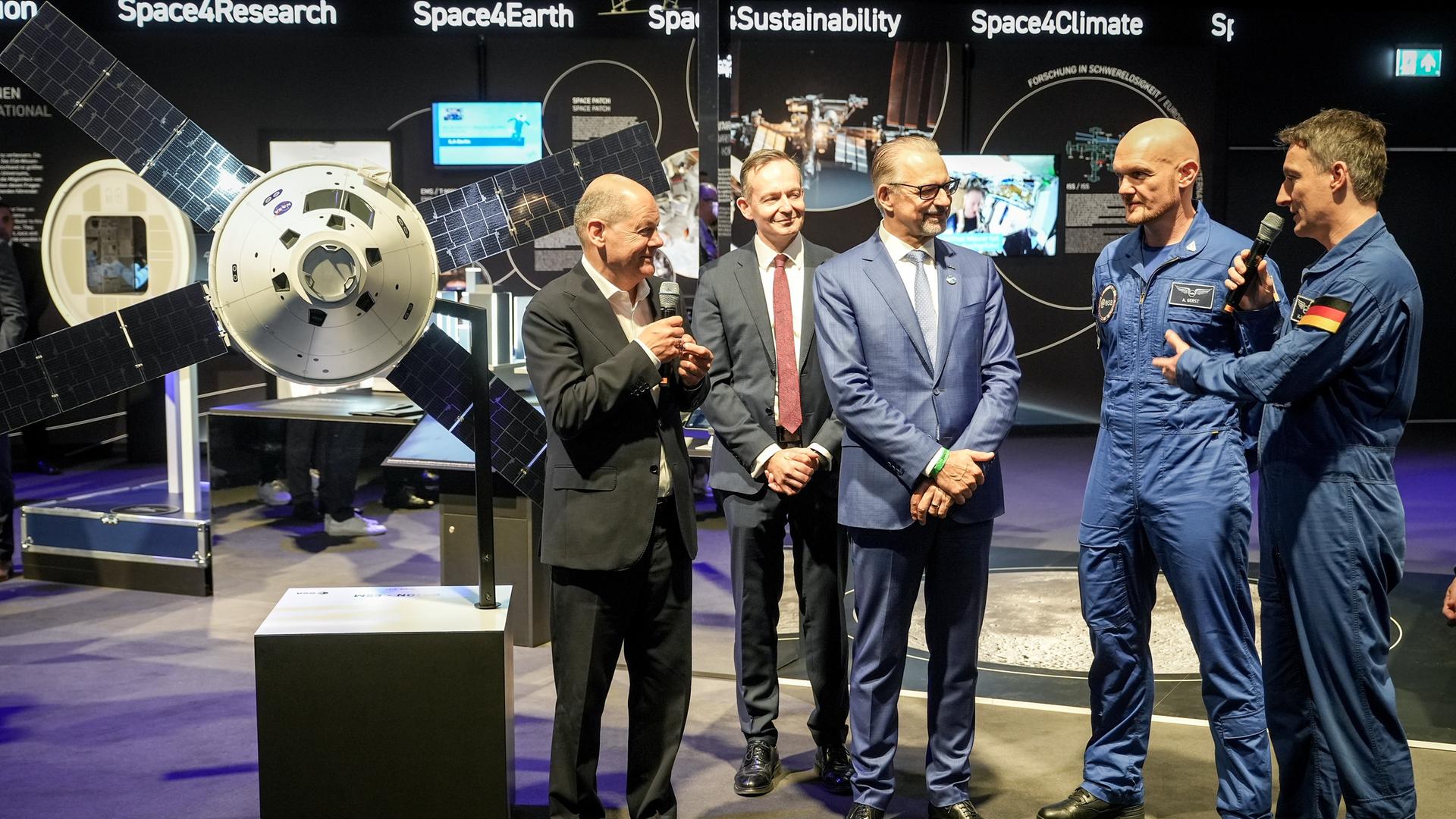 Brandenburg, Schönefeld: Bundeskanzler Olaf Scholz (l-r, SPD) mit Volker Wissing (FDP), Bundesminister für Verkehr und Digitales, Astronaut Alexander Gerst und Matthias Maurer während des Eröffnungsrundgangs auf der Internationalen Luft- und Raumfahrtausstellung (ILA) auf dem Gelände vom Flughafen Berlin Brandenburg (BER) am Stand von der ESA. 