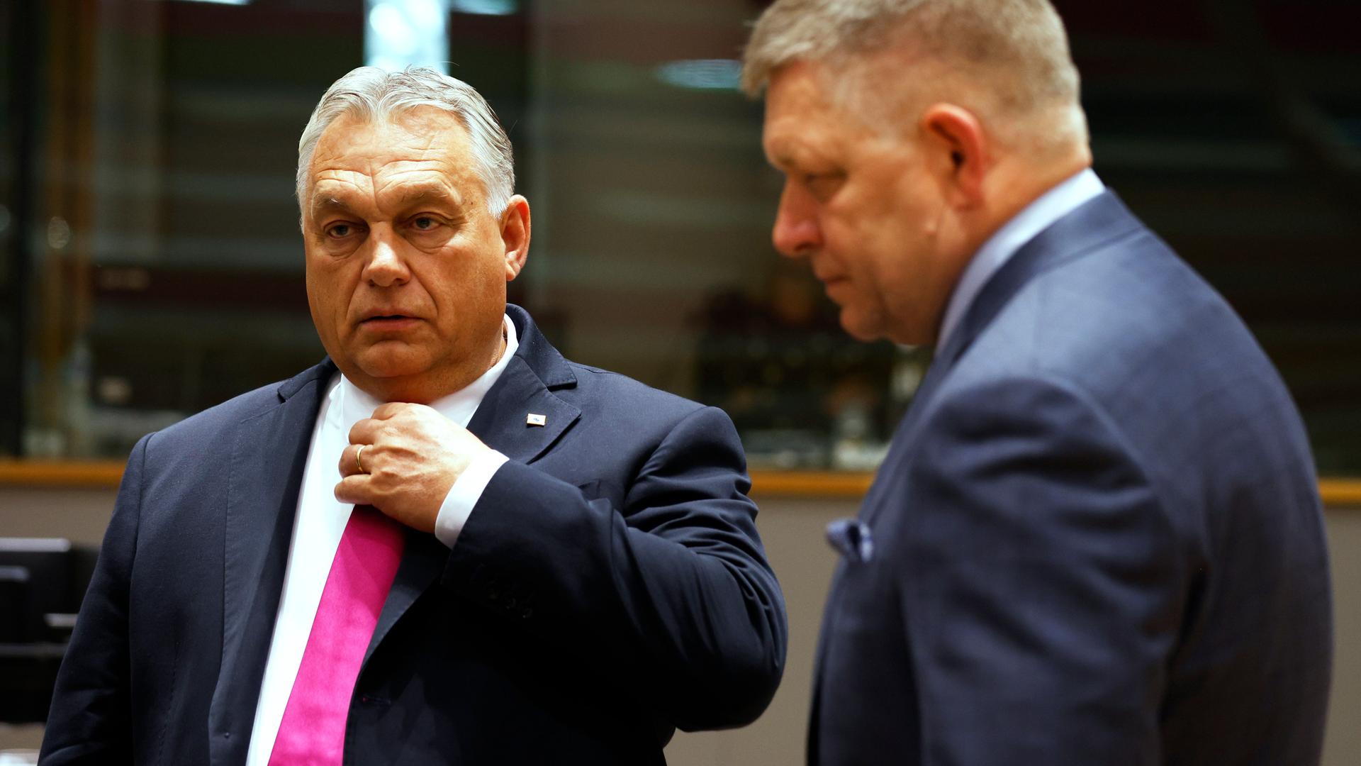 Der ungarische Ministerpräsident Orban spricht mit seinem Amtskollegen aus der Slowakei, Fico. Beide tragen dunkelblaue Anzüge, Fico verschwindet auf der rechten Seite stehend, in Unschärfe. Aufnahme vom EU-Gipfel in Brüssel, 26.10.2023. Der ungarische Ministerpräsident Orban spricht mit seinem Amtskollegen aus der Slowakei, Fico. Beide tragen dunkelblaue Anzüge, Fico verschwindet auf der rechten Seite stehend, in Unschärfe. Aufnahme vom EU-Gipfel in Brüssel, 26.10.2023.
