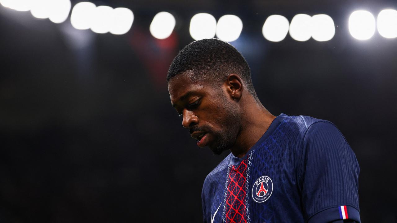 Ousmane Dembélé trägt das Trikot von Paris Saint-Germain. Er steht im Stadion vor einem dunklen Hintergrund.