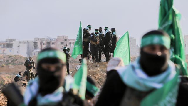 Palästinensische Hamas-Kämpfer versammeln sich am 20. Februar 2025 am Ort der Übergabe der Leichen von vier israelischen Geiseln in Khan Yunis im südlichen Gazastreifen. Palästinensische Hamas-Kämpfer versammeln sich am 20. Februar 2025 am Ort der Übergabe der Leichen von vier israelischen Geiseln in Khan Yunis im südlichen Gazastreifen.