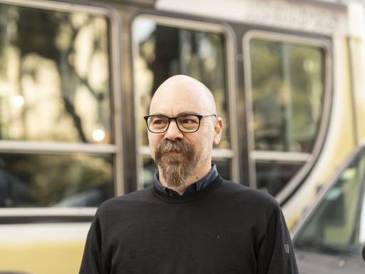 Der argentinische Schriftsteller Ariel Magnus, aufgenommen im Freien vor einem Berliner Linienbus