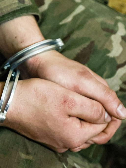 Die gefesselten Hände eines ukrainischen Soldaten.