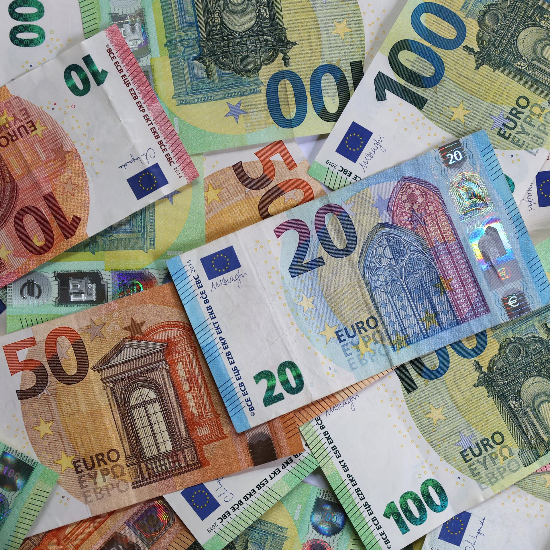 Verschiedene Euro-Banknoten liegen auf einem Tisch.