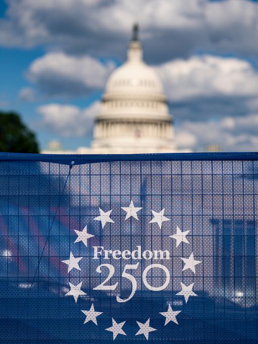 Das US-Kapitol ist hinter dem „Freedom 250“-Logo hinter einem Bauzaun zu sehen.