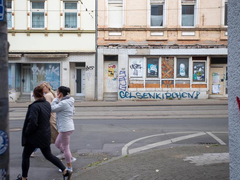 Eine Häußerfassade ist mit Bretterverschlägen versiegelt und wurde mit Grafitti verunstaltet Eine Häußerfassade ist mit Bretterverschlägen versiegelt und wurde mit Grafitti verunstaltet
