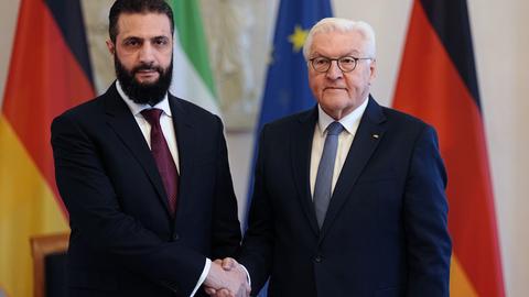Syriens Übergangspräsident Ahmed al-Scharaa und Bundespräsident Frank-Walter Steinmeier schütteln sich im Schloss Bellevue die Hand.