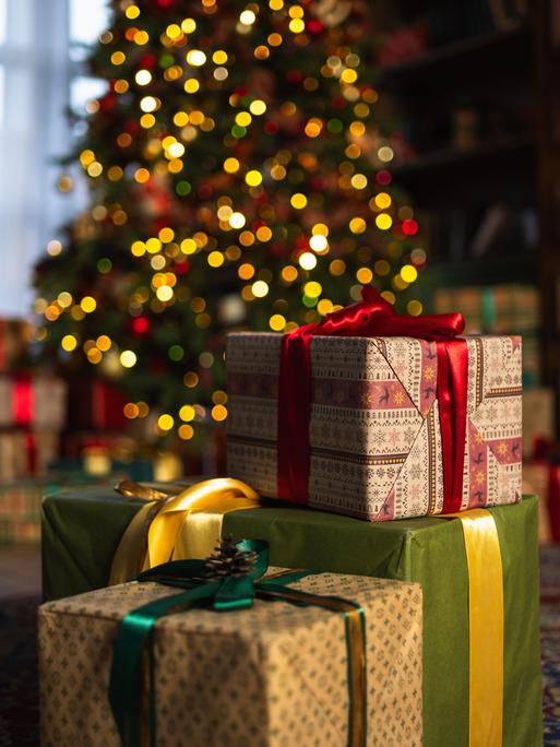 Viele Geschenke stehen vor einem Weihnachtsbaum