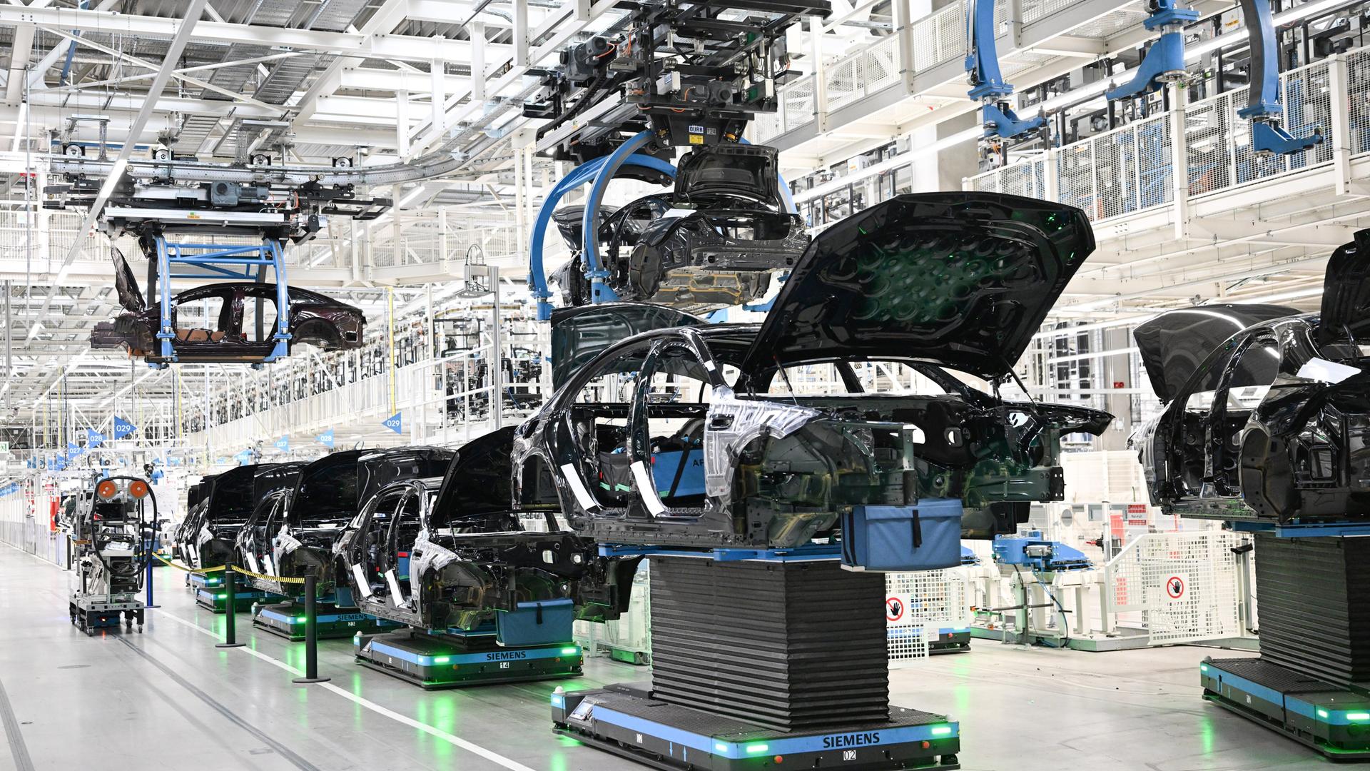 In einer Fabrik in Sindelfingen werden Karosserien für Mercedes-Benz-Fahrzeuge automatisiert transportiert.