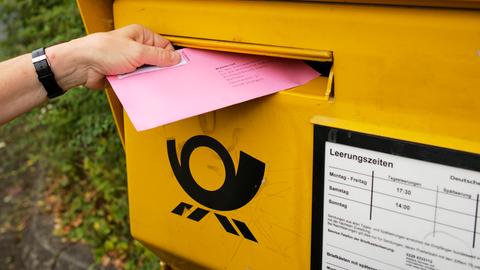 Ein Wahlbrief wird in einen Briefkasten der Deutschen Post gesteckt. Ein Wahlbrief wird in einen Briefkasten der Deutschen Post gesteckt.