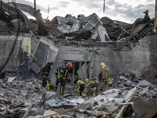 Blick auf ein von Raketen zerstörtes Restaurant im ukrainischen Kramatorsk, in dem Feuerwehrleute nach den Opfern suchen. 