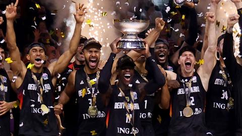Dennis Schröder (Deutschland) hält die Trophäe und jubelt nach dem Basketball-EM-Sieg mit den Teamgefährten.