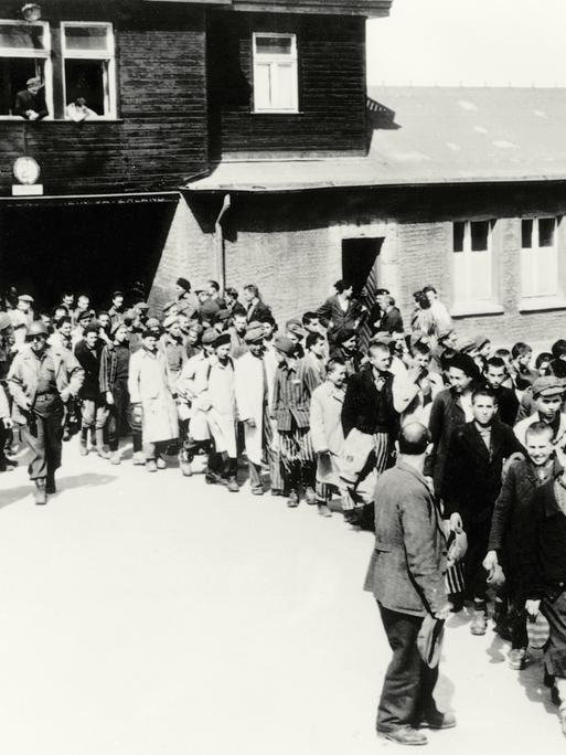 Schwarz-weißes Foto: Menschen verlassen das KZ Buchenwald nach der Befreiung am 11. April 1945.