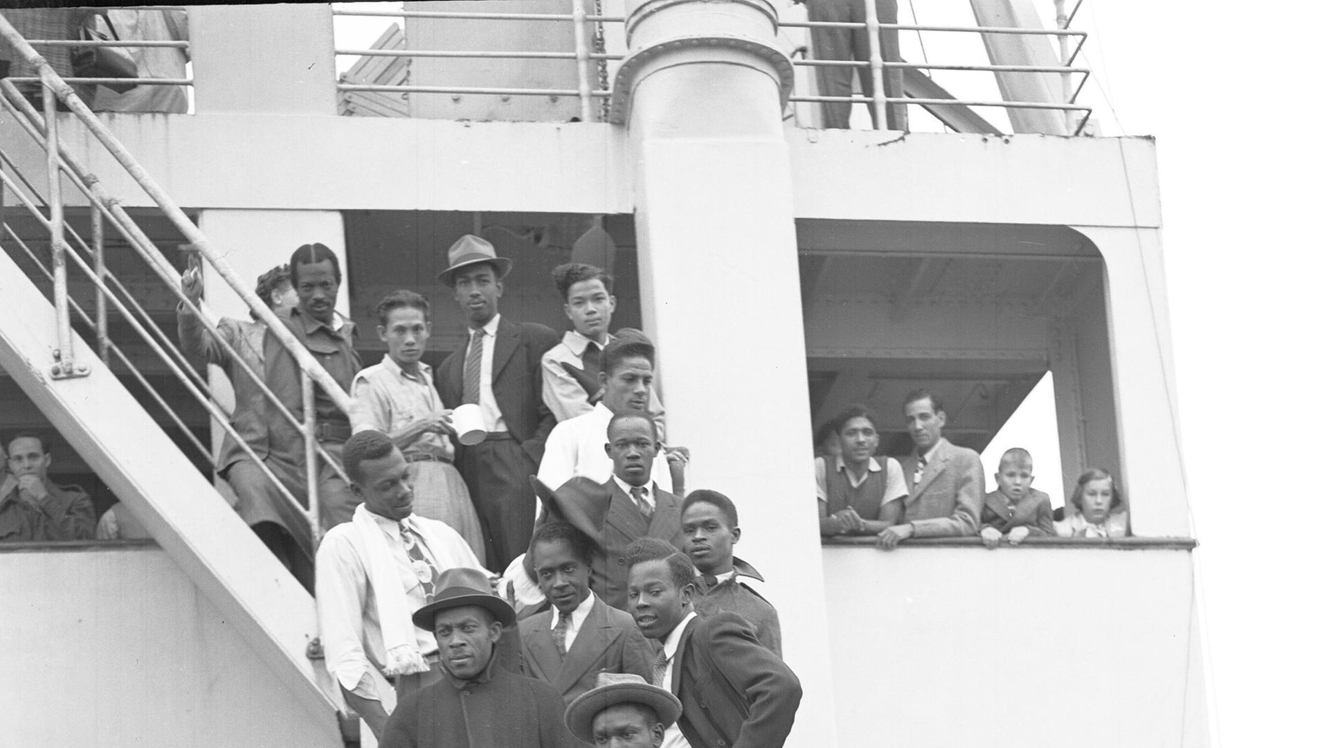 Some of the Jamaican men, mostly ex Royal Air Force servicemen, aboard the former troopship, S.S. Empire Windrush, before disembarking at Tilbury Docks, England, on June 22, 1948. They have come to Britain seeking employment. (AP Photo/Staff/Worth) 