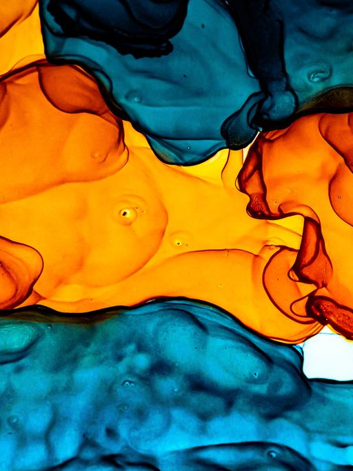 Abstrakte Alkoholmalerei in Orange und Blautönen.