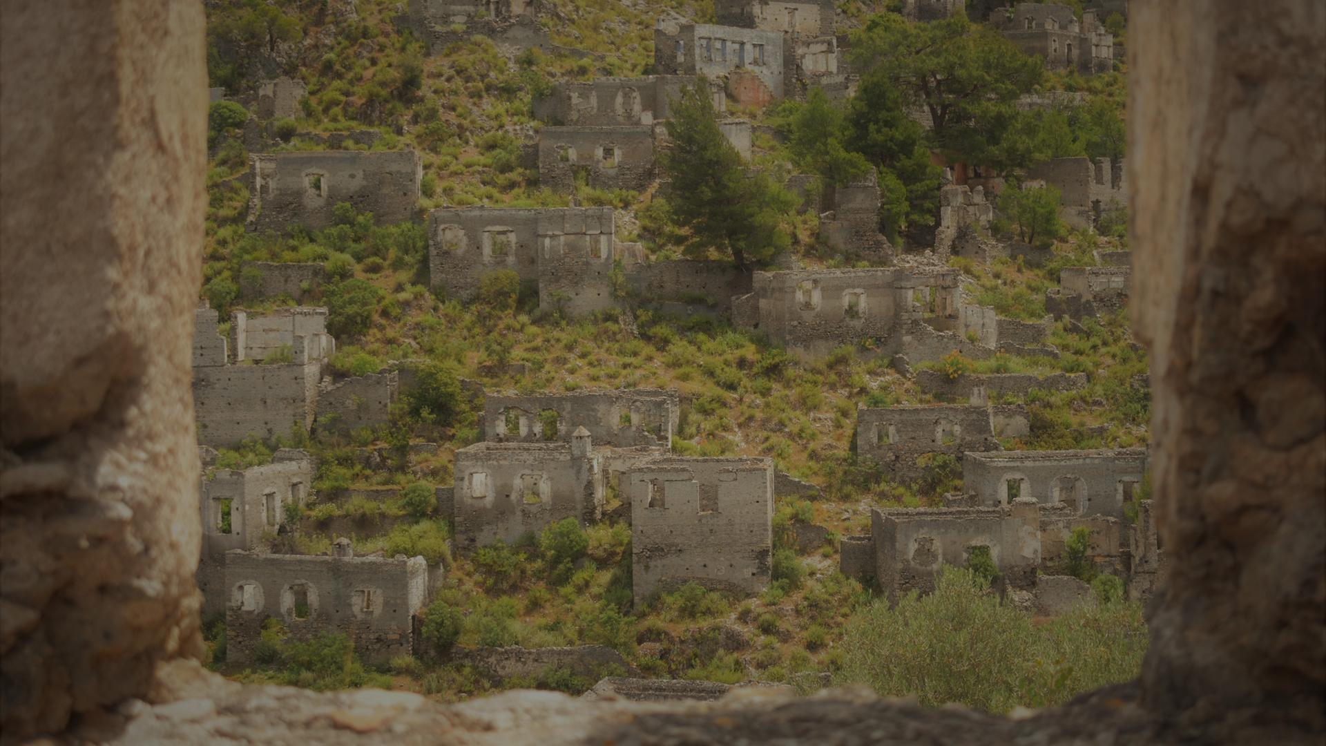Ein verlassenes Dorf: Durch Steinmauern blickt man auf Ruinen.