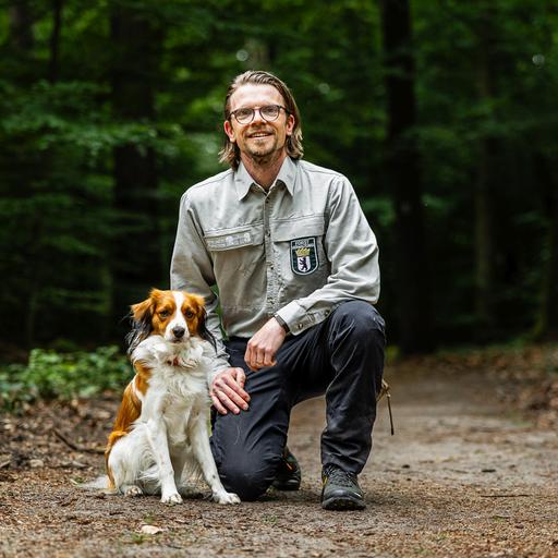 Das Bild zeigt den Revierleiter und Förster Peter Harbauer mit seinem Hund Juri.