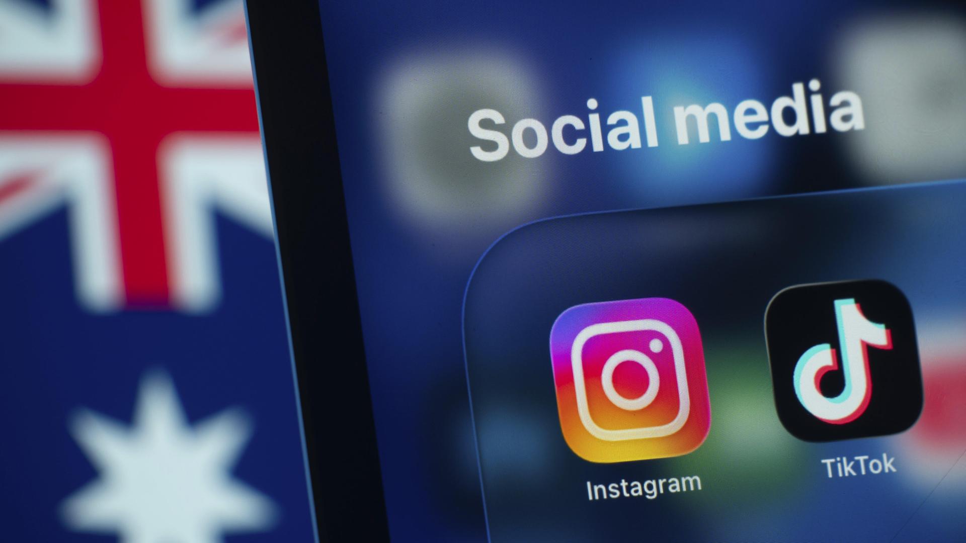 Auf einem Smartphone-Bildschirm wird die Instagram und Tiktok App mit einer australischen Flagge im Hintergrund angezeigt. Auf einem Smartphone-Bildschirm wird die Instagram und Tiktok App mit einer australischen Flagge im Hintergrund angezeigt.