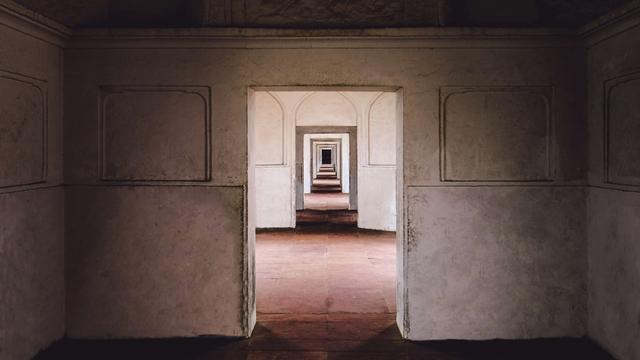 Ein leeres Gebäude in Lahore, Pakistan: Blick durch eine Tür, die zu einem leeren Raum mit Tür führt, die zu einem leeren Raum mit Tür führt, die zu einem leeren Raum mit Tür führt usw...