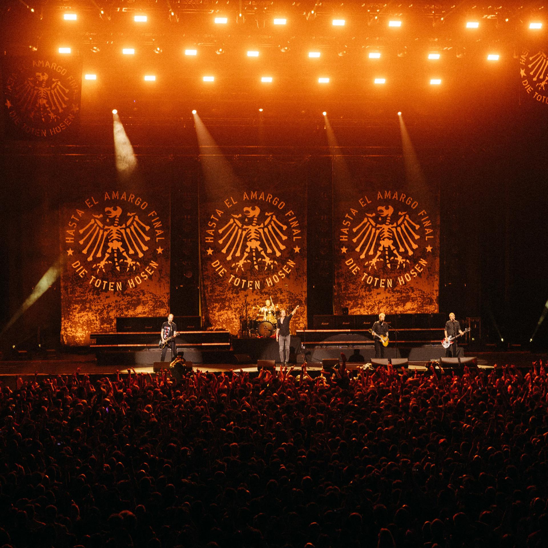 Das Abschiedskonzert der Toten Hosen in Argentinien in der Movistar Arena von Buenos Aires: Die Musiker stehen auf einer riesigen Bühne; im Vordergrund sind viele Zuschauer zu sehen.