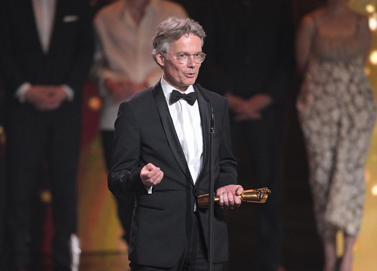 Ingo Fliess, Produzent von "Das Lehrerzimmer", steht bei der Verleihung des Deutschen Filmpreises im Mai 2023 mit dem Preis für die "Lola in Gold" für den Film auf der Bühne.
