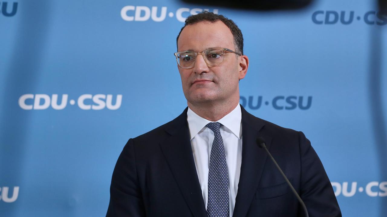Jens Spahn steht vor einer Wand mit dem Logo der CDU/CSU-Bundestagsfraktion.