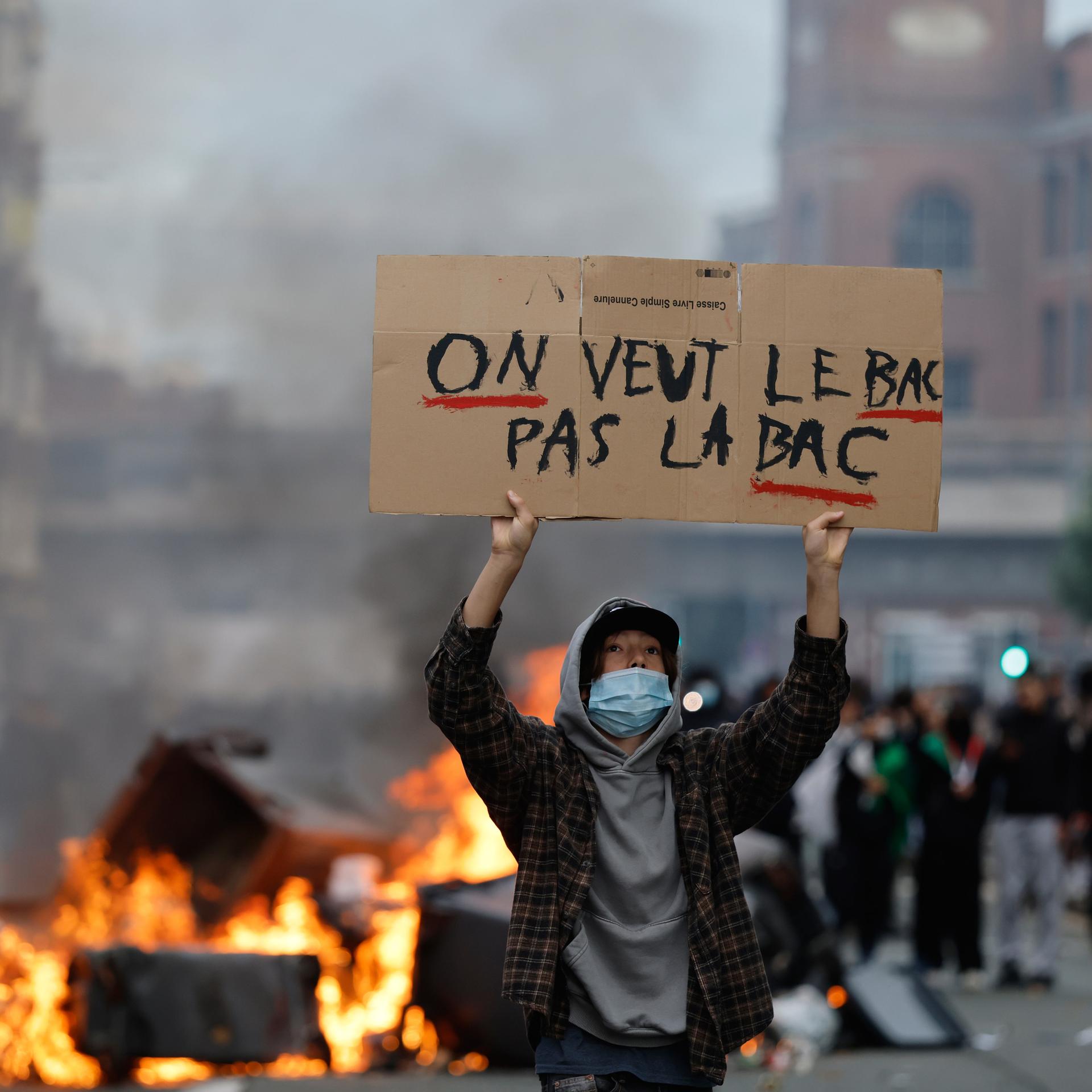 Frankreich, Lille: Ein Schüler hält während einer Demonstration für mehr Mittel und mehr Personal an der Schule ein Schild mit der Aufschrift "Wir wollen das BAC (Abitur), nicht die BAC (Einheiten zur Verbrechensbekämpfung)»"hoch. 