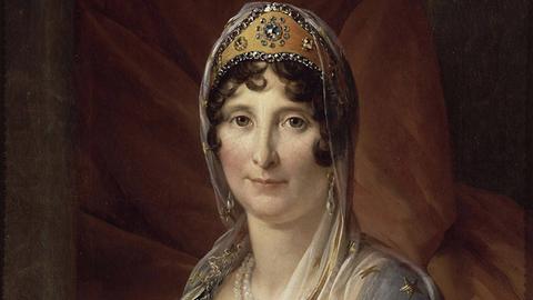 Gemälde einer Frau; sie blickt gerade aus direkt zum Betrachtenden. Sie trägt eine Art Krone. Es ist ein Porträt von Maria Letizia Ramolino Bonaparte (1750–1836), Mutter von Napoleon Bonaparte, um 1804.