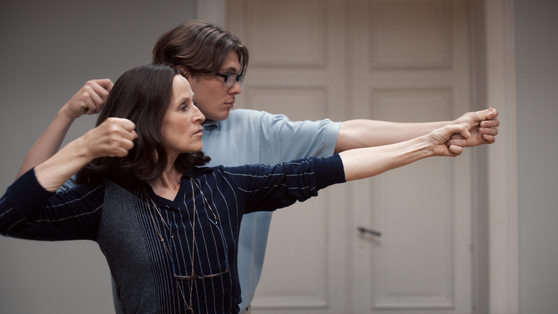 Sophie Rois und Milan Herms spannen in einer Filmszene zusammen einen imaginären Bogen. Sophie Rois und Milan Herms spannen in einer Filmszene zusammen einen imaginären Bogen.