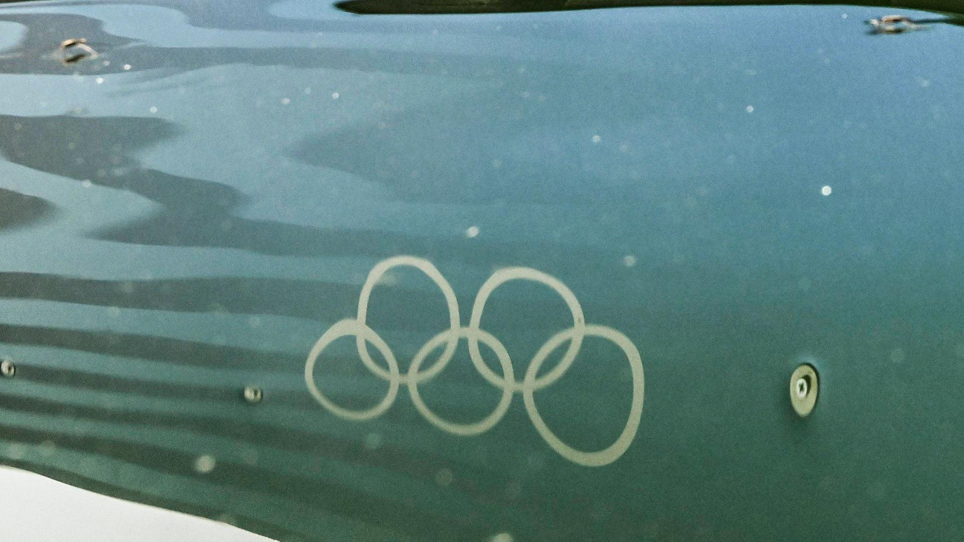 Die Olympischen Ringe spiegeln sich im Wasser der Seine.