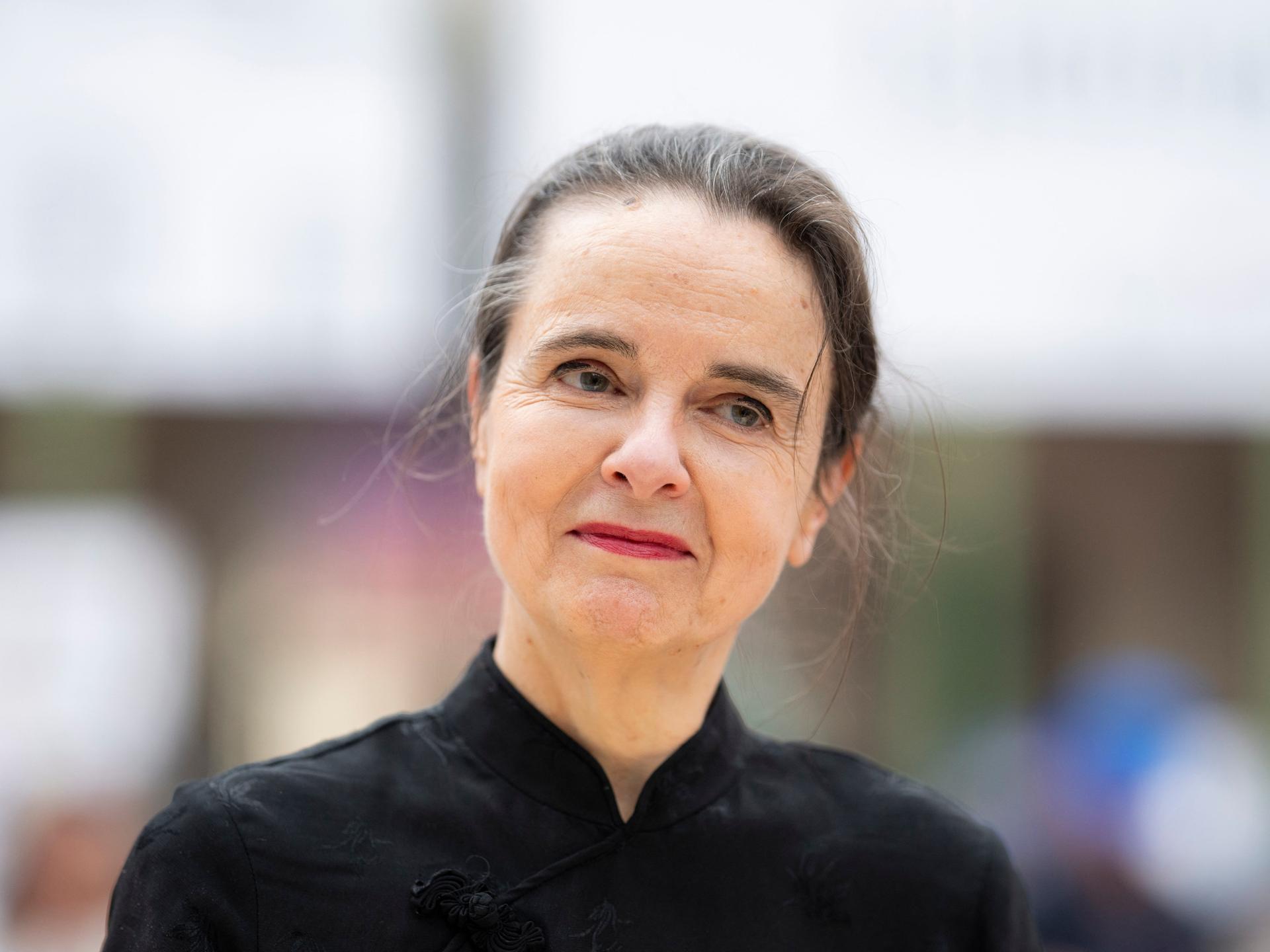 Amélie Nothomb neigt im Gespräch lächelnd den Kopf zur Seite.