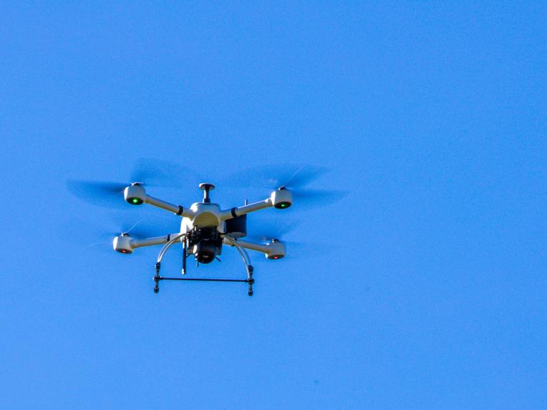 Eine Drohne schwebt im blauen Himmel Eine Drohne schwebt im blauen Himmel