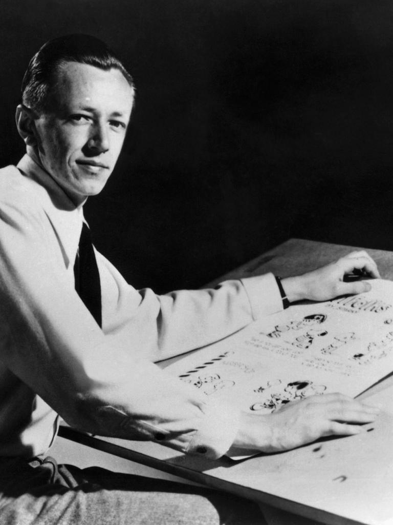 Charles M. Schulz (1922–2000), US-amerikanischer Cartoonist und Schöpfer des Comics „Peanuts“ am Zeichenbrett in einer schwarz-weiß Aufnahme von 1952.