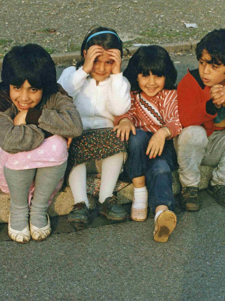 1990: Kinder mit türkischen Wurzeln sitzen auf einem Bordstein.