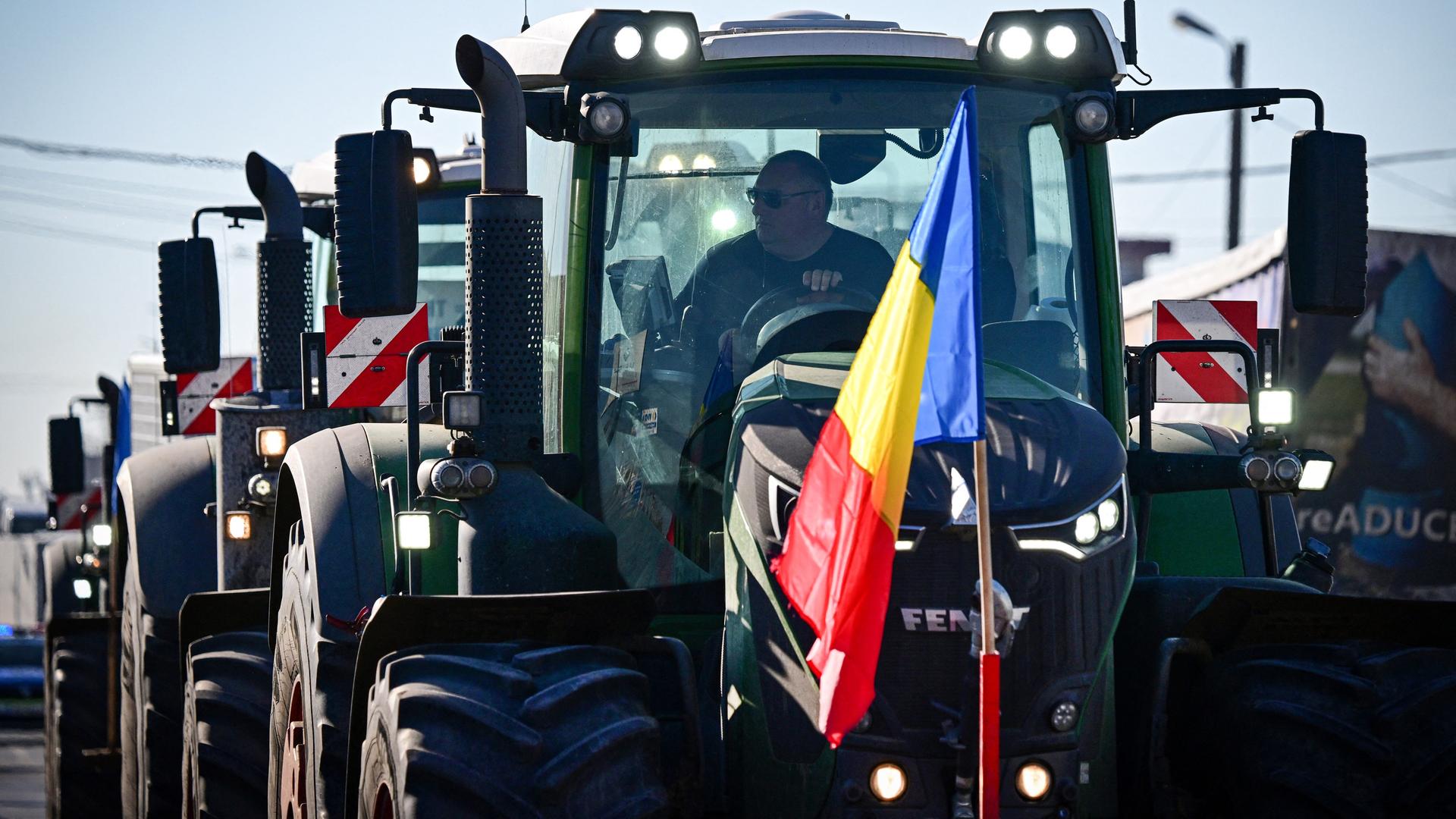 Rumänische Landwirte auf dem Weg an die Grenze zur Ukraine. Der vorderste Traktor hat eine rumänische Flagge am Kühler befestigt. Rumänische Landwirte auf dem Weg an die Grenze zur Ukraine. Der vorderste Traktor hat eine rumänische Flagge am Kühler befestigt.
