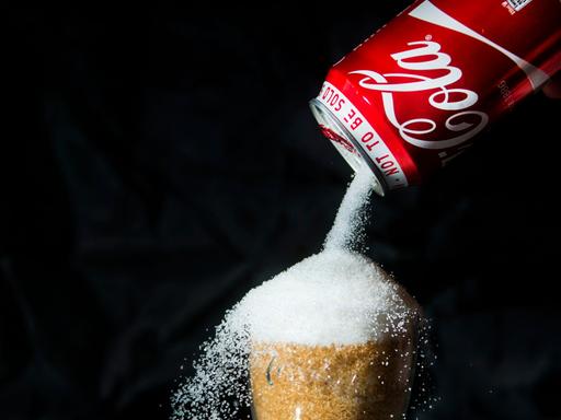 Illustration zur Darstellung des hohen Zuckergehalts in Coca-Cola.