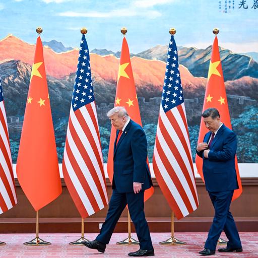 US-Präsident Donald Trump und der chinesische Staatschef Xi Jinping gehen vor chinesischen und US-Flaggen entlang.