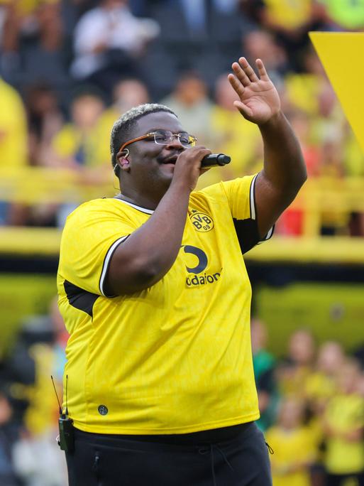 Der Sänger Rayan Djima von der Band Blumengarten singt bei der Saisoneröffnung von Borussia Dortmund den Sommerhit "Du bist gut genug"