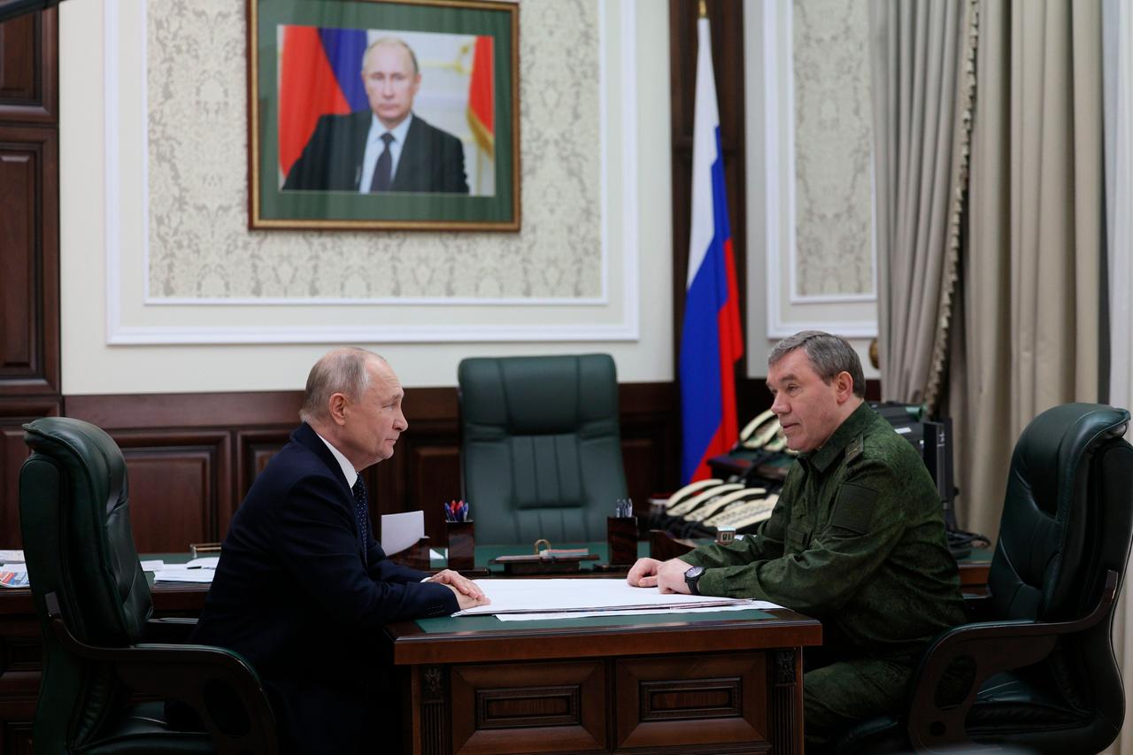 Russian President Vladimir Putin, left, and Russian Chief of General Staff Valery Gerasimov talk to each other at the headquarters of Russia's Southern Military District in Rostov-on-Don, Russia, Thursday, Oct. 19, 2023. (Gavriil Grigorov, Sputnik, Kremlin Pool Photo via AP)